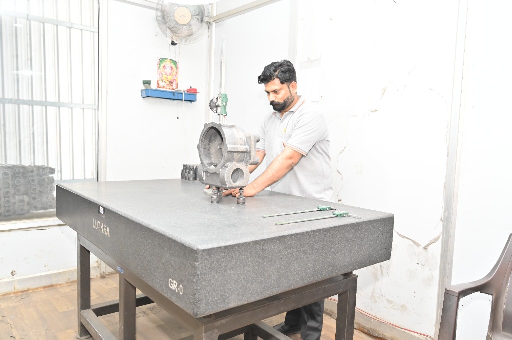 Quality inspector verifying cast iron component dimensions on Luthra GR-0 granite surface plate